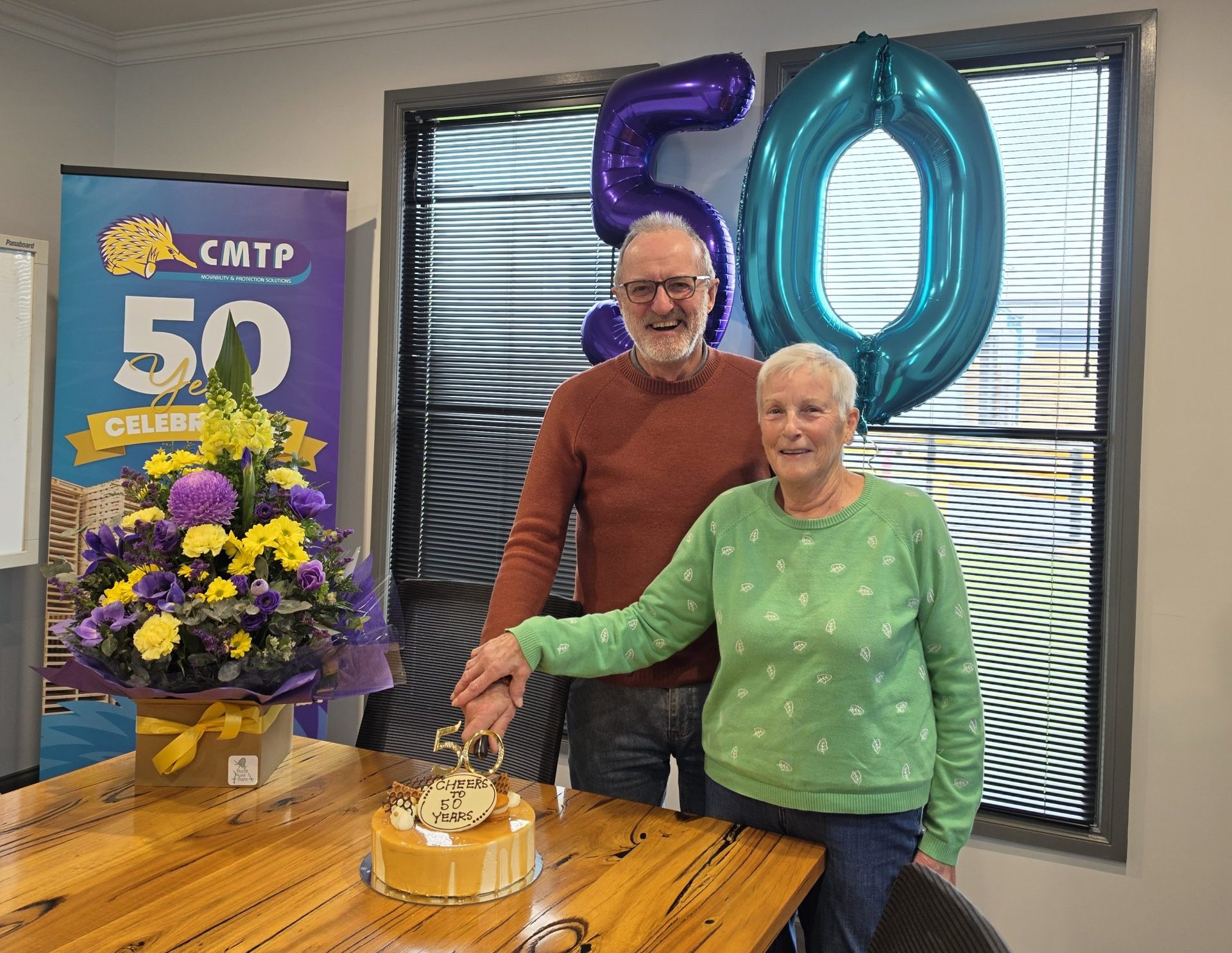 Chris and Marilyn Meade cutting a cake at CMTP's 50th anniversary celebration.