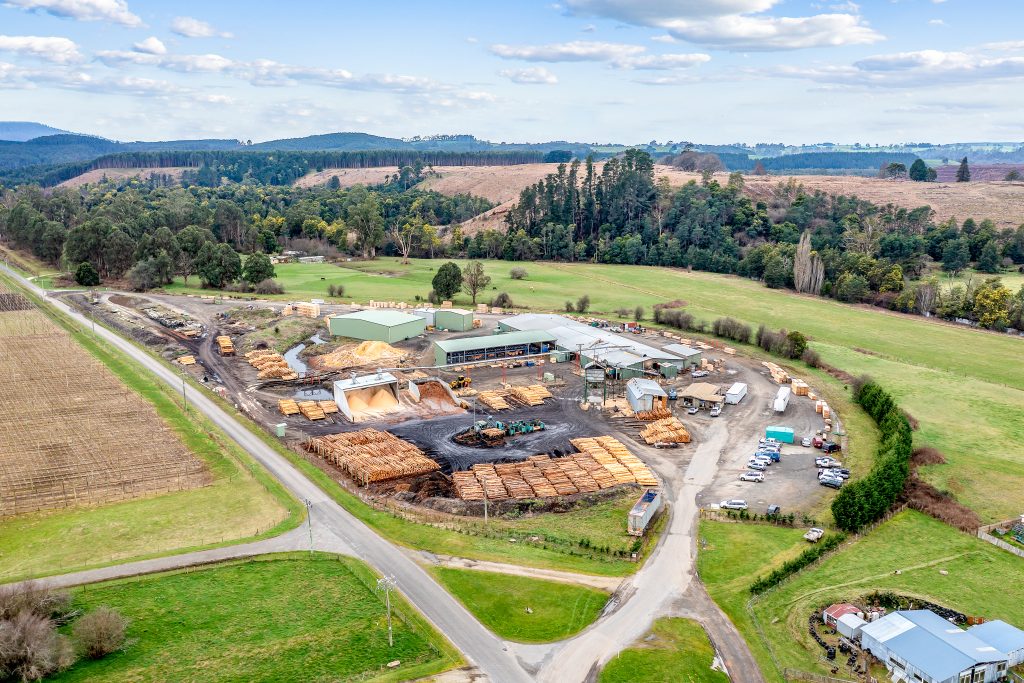 The CMTP Branxholm site with its sheds and yard, set among the hills of north-east Tasmania