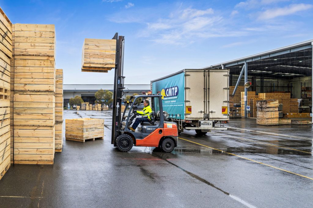 A forklift driver working outside in the yard at the CMTP Edinburgh site in Adelaide's north