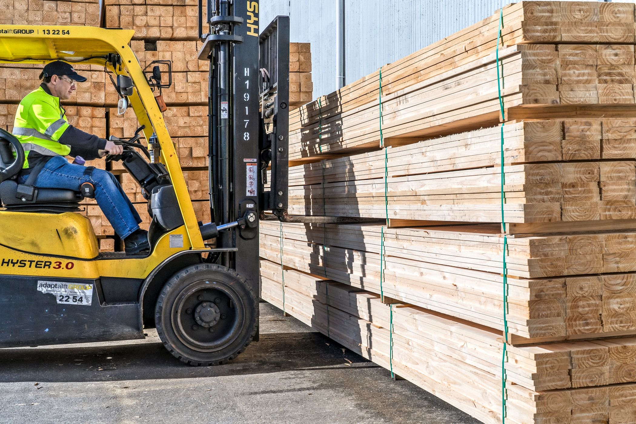 Forklift driver carrying a stack of timber at CMTP, ready to be made into pallets and cases for manufacturing customers